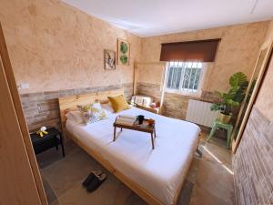 a small bedroom with a bed with a table on it at La Mayor del Viso in Toledo