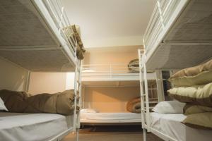 a bedroom with two bunk beds and a window at Pella Inn Hostel in Athens