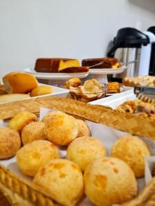 a table filled with trays of bread and pastries at Arcos Palace Hotel in Arcos