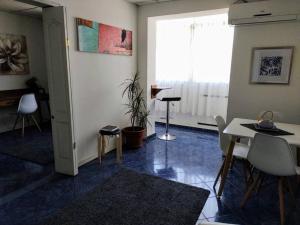 a living room with a table and chairs and a window at Estado Apart 103 Full equipado hermoso in Santiago