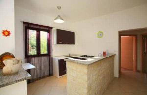 a kitchen with a counter and a stove top oven at Apartment with pool Adria in Marčana