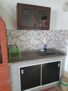 a kitchen with a sink and a counter top at Cantinho da Bethânia in São Pedro da Aldeia