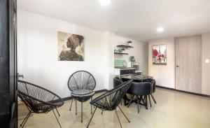 a dining room with black chairs and a table at Bahari Cartagena Suites in Cartagena de Indias