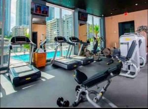 a gym with cardio equipment in a building at Modern apartment A - Beach Walk Resort in Hallandale Beach
