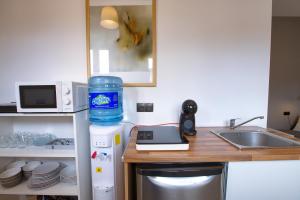 a kitchen with a counter with a water bottle on it at Cuencaloft Matadero viejo in Cuenca