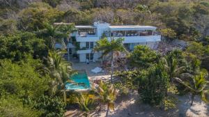 an aerial view of a white house in the forest at Villa Deluxe Los Cocos Baru in Baru