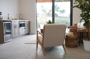 a kitchen with a chair in the middle of a room at Hidden Hacienda in Temecula