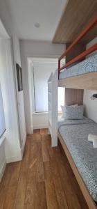 a bedroom with a bunk bed and a staircase at S Soares Beato 6 3D in Lisbon