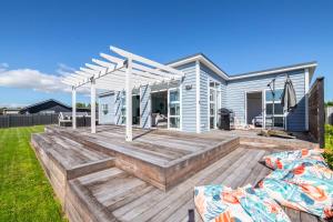a wooden deck in front of a house at Blue Bungalow in Martinborough 