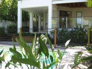 a house with a fence and a plant in front of it at Moorindil Street in Tewantin