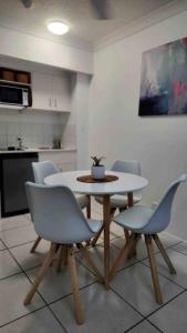 a white table and chairs in a kitchen at 3 BLOCKS to SURFERS PARADISE BEACH in Gold Coast
