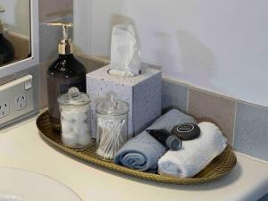 a tray with towels and other items on a bathroom counter at 3 BLOCKS to SURFERS PARADISE BEACH in Gold Coast