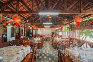 una sala da pranzo con tavoli, sedie e luci cinesi di Khách sạn Bình Dương a Quy Nhon