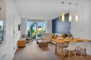 a living room with a table and a living room with a couch at Modern apartment in luxury condominium AB- 2 bed/2 ba in Hallandale Beach