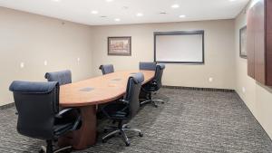 a conference room with a wooden table and chairs at Estherville Hotel & Suites in Estherville +81 photos