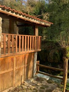 a wooden deck with a wooden gate and a fence at Quinta das Bollótâs in Travassós