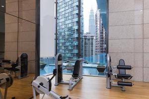 a gym with a view of a city skyline at Opus Bukit Bintang in Kuala Lumpur
