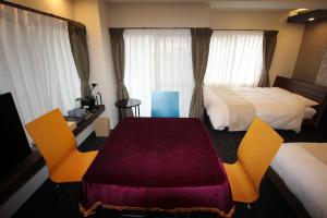 Postel nebo postele na pokoji v ubytování AYA Hotel