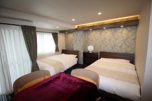Postel nebo postele na pokoji v ubytování AYA Hotel
