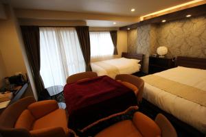Postel nebo postele na pokoji v ubytování AYA Hotel