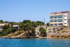 a building on the shore of a body of water at Sovalye Hotel in Fethiye