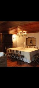 a dining room with a long table and chairs at Casa do Monte in Vizela