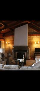 a living room with a fireplace and a large screen at Casa do Monte in Vizela