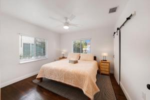 a bedroom with a bed and a ceiling fan at Miami Art Deco Home By Pmi in Miami