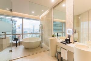 a bathroom with a tub and two sinks and a window at Atelier Bukit Bintang in Kuala Lumpur