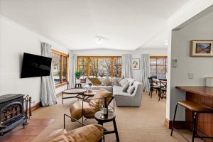 a living room with a couch and a fireplace at Aberdeen Cottage - Nestled in the Heart of Arrowtown - New! in Arrowtown