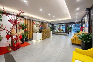 a lobby of a store with flowers and plants at San Premium Hotel in Hanoi