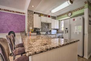 a kitchen with a marble counter top and a refrigerator at Royal Aloha Wakiki Sweet Home in Honolulu