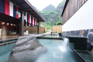 a pool of water in front of a building at Yoko Onsen Quang Hanh in Cẩm Phả