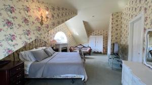 a bedroom with a bed with floral wallpaper at Bedham Hall B&B in Niagara Falls