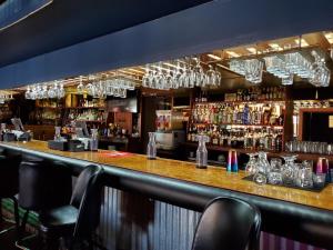 a bar with a lot of wine glasses at Happy Bay in Bay City