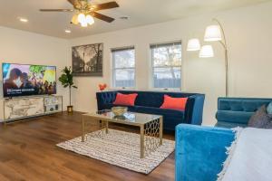 a living room with a blue couch and a table at Spacious Home Near Herndon/Dulles Airport/Ashburn in Sterling