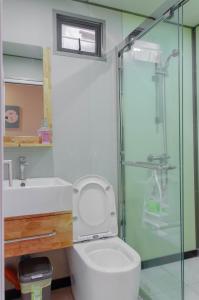 a bathroom with a toilet and a glass shower at Moriyama Hotel in Mandaue City