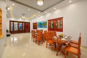 a dining room with a table and chairs at Hanoi Airport Suites in Sóc Sơn