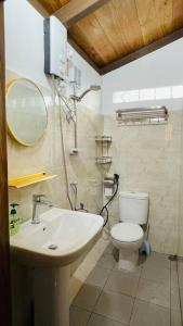 a bathroom with a sink and a toilet at A Luxury Duplex in Dili City, Timor-Leste in Dili