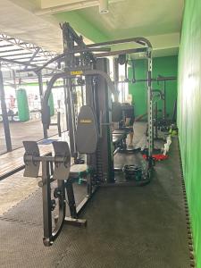 a gym with lots of equipment in a room at Rawai Beachside Hotel in Rawai Beach