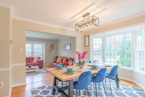 a dining room with a table and blue chairs at Stunning Vacation Home /Private Theatre/Fire pit in Fairfax