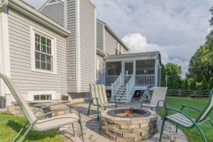 a patio with chairs and a fire pit in front of a house at Stunning Vacation Home /Private Theatre/Fire pit in Fairfax