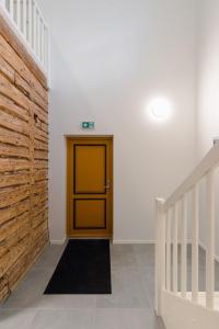 a hallway with a yellow door and a staircase at Posti Guesthouse in Rakvere