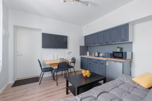 a kitchen and a living room with a couch and a table at Posti Guesthouse in Rakvere