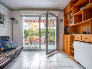 a living room with a door open to a patio at Appartement RDC avec terrasse, piscine et parking à 1km de la plage - FR-1-2-418 in Hendaye
