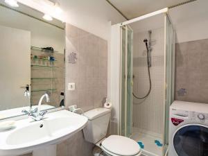 a bathroom with a sink and a toilet and a shower at Appartement RDC avec terrasse, piscine et parking à 1km de la plage - FR-1-2-418 in Hendaye