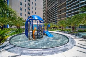 un patio de recreo en un parque con palmeras en The Sóng Apartment Vũng Tàu - Mita House, en Vung Tau