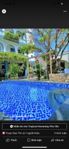 a screenshot of a photo of a large swimming pool at Tropical Homestay Phu Yen in Tuy Hoa