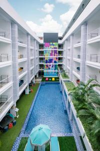 an apartment building with a pool in the middle at Viva Dash Hotel Seminyak in Seminyak