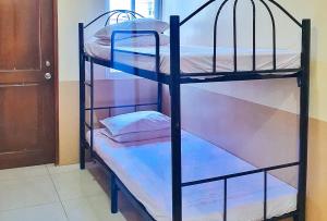 a couple of bunk beds in a room at RedDoorz @ RSL Transient House Iloilo in Iloilo City